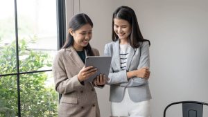 Two professionals reviewing tablet